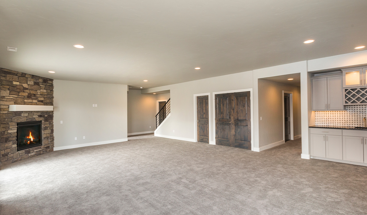 Newly remodeled basement with carpet and solid ceiling