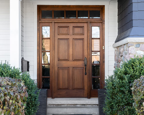 New wooden door with sidelights on residential home