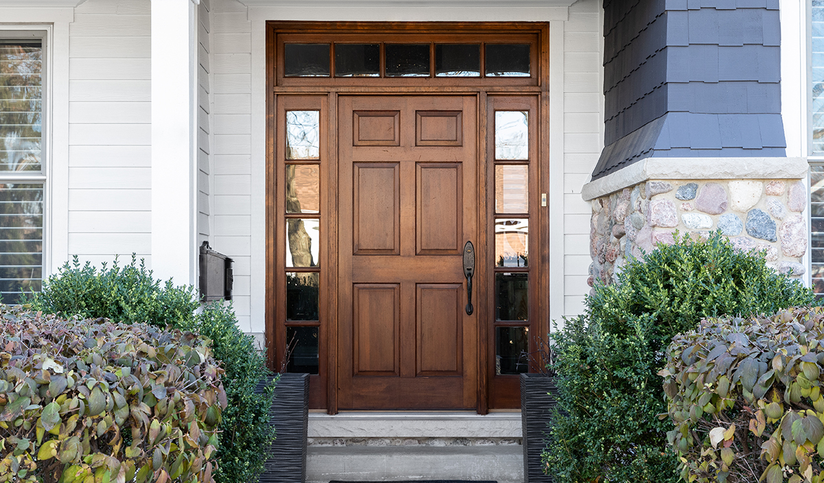 New wooden door with sidelights on residential home